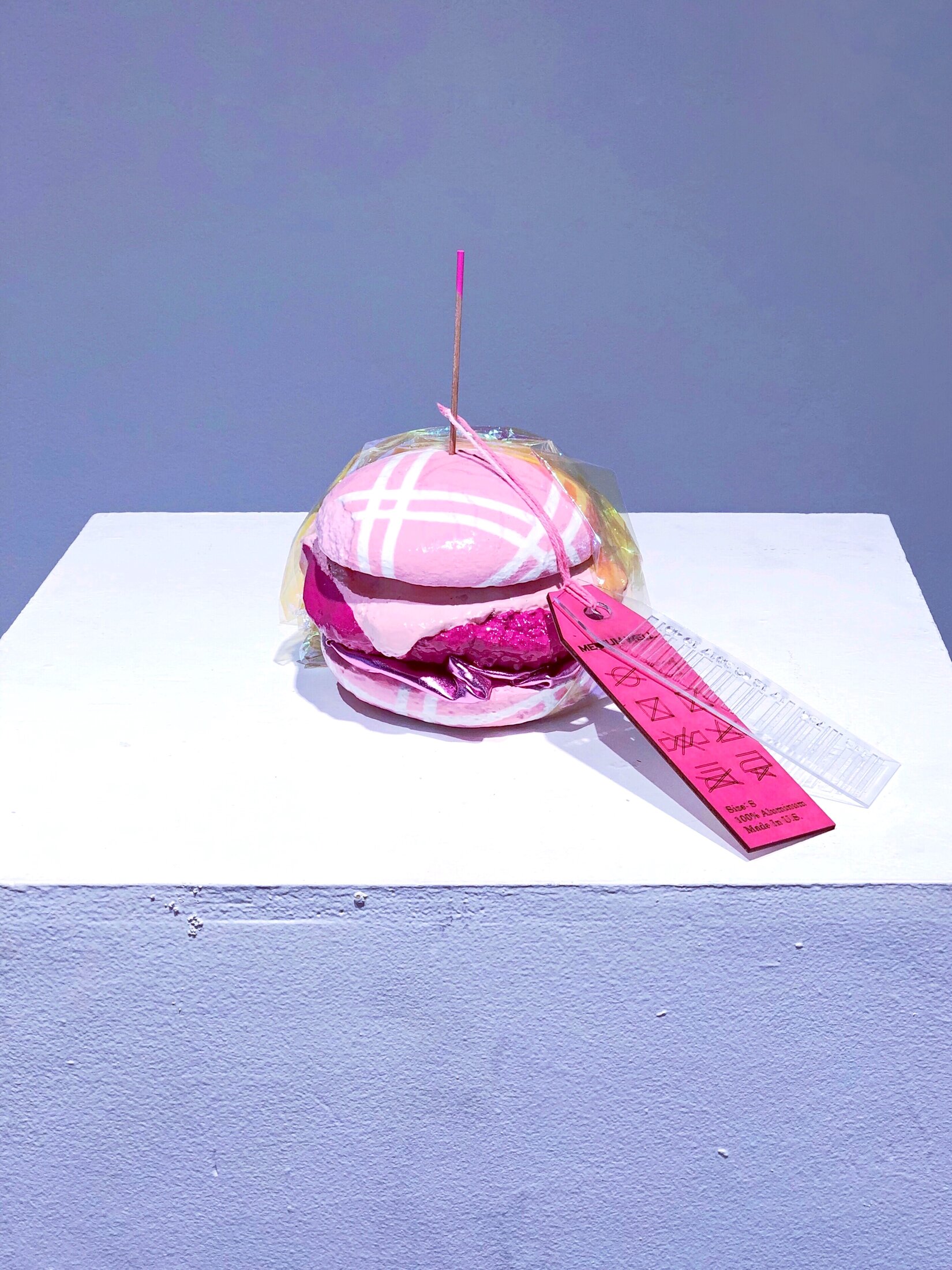 Medium Well, a cast aluminum hamburger sculpture painted in shades of pink