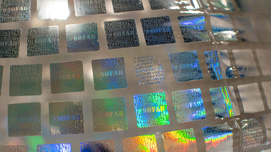 Unsealing the Globe, a disco globe covered in hologram security stickers
